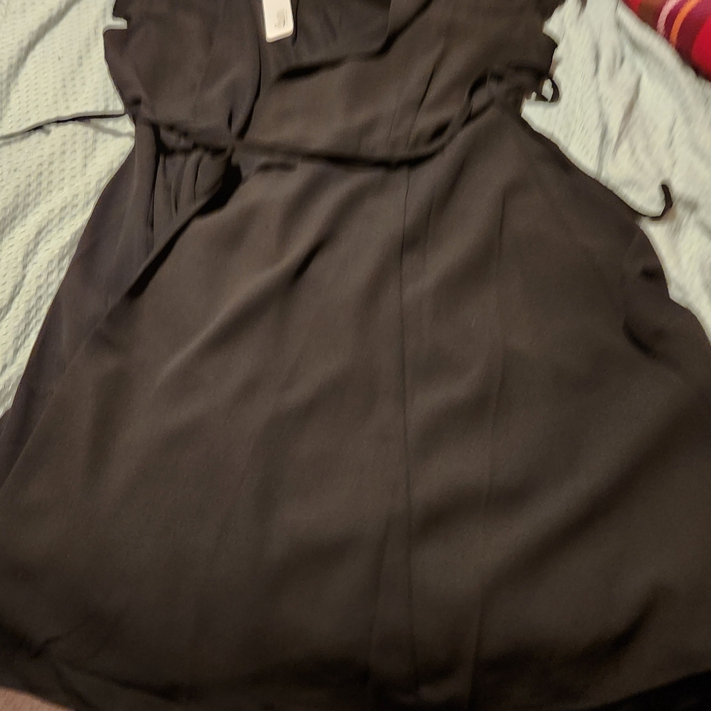 Black wrap around dress.  Ruffle cap sleeve. By glam size large.